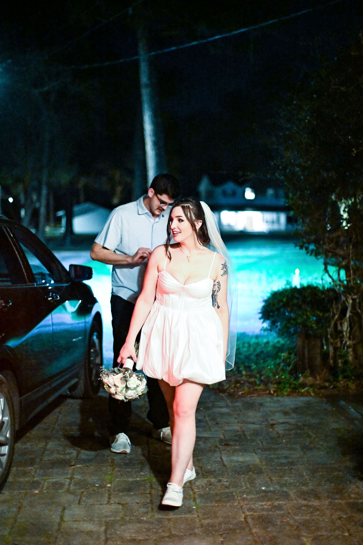 A romantic evening photo at a venue with a couple illuminated by blue lighting.