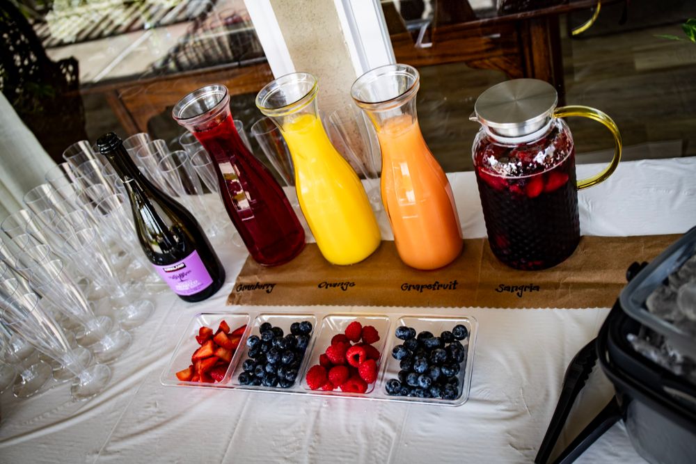 Beverage station with fruit juices and berries for a party.