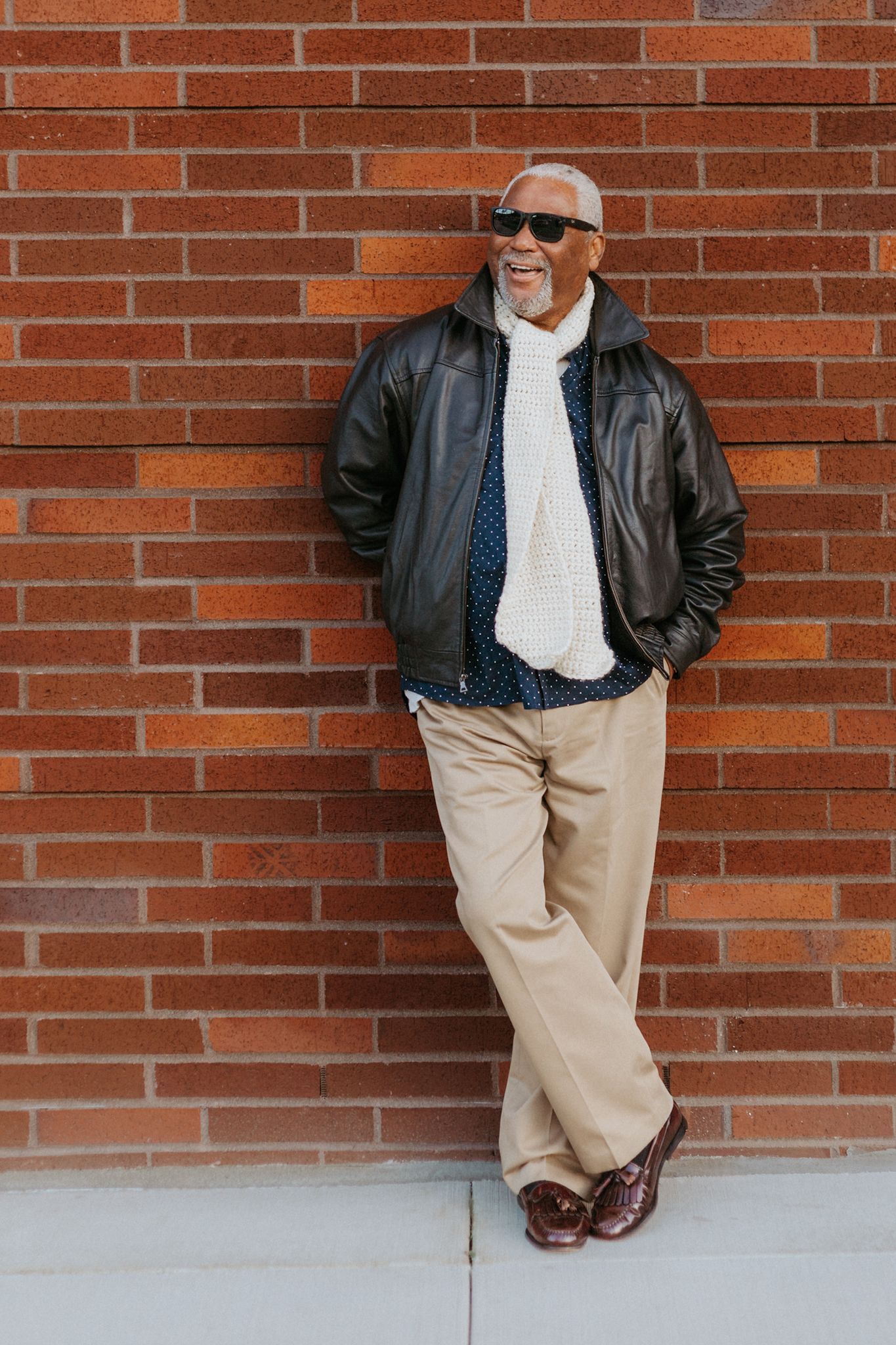 A sequence of photos showing someone in a red leather jacket smiling and laughing against an urban backdrop.