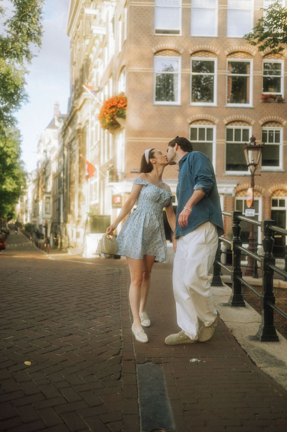 Playful scene on cobblestone street with historic Dutch architecture in background.