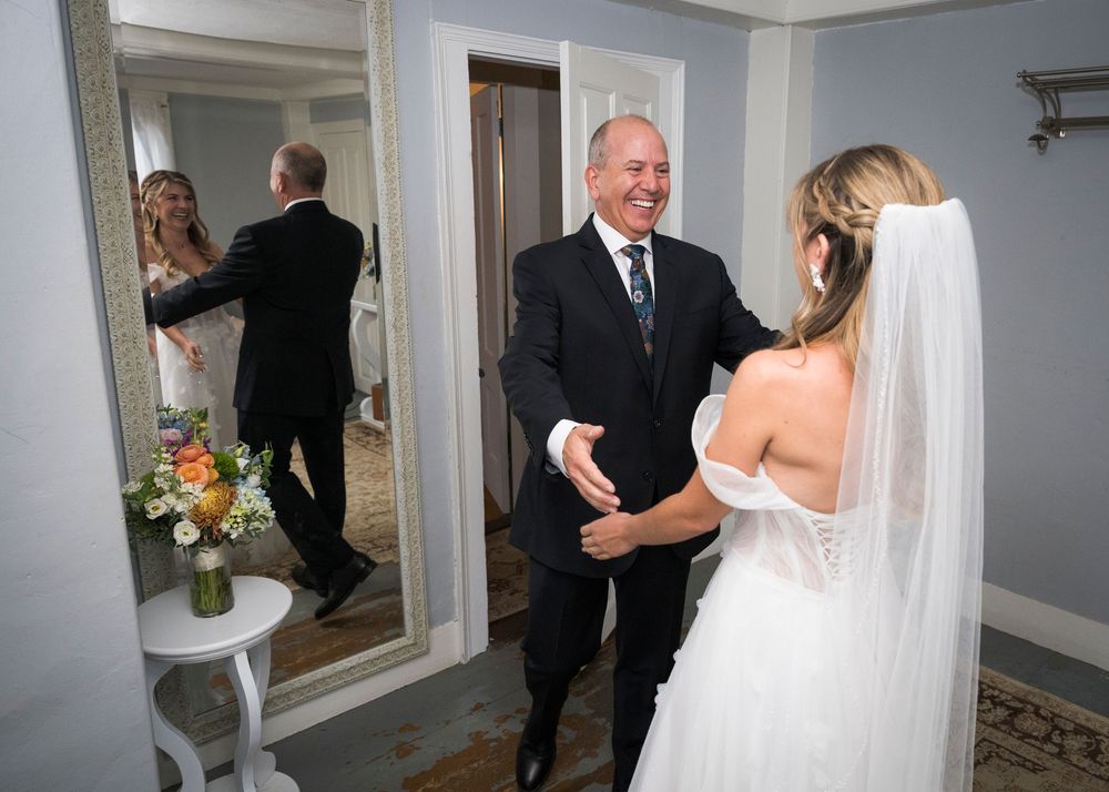 A series of candid moments captured in a hallway as wedding party members prepare for the ceremony.