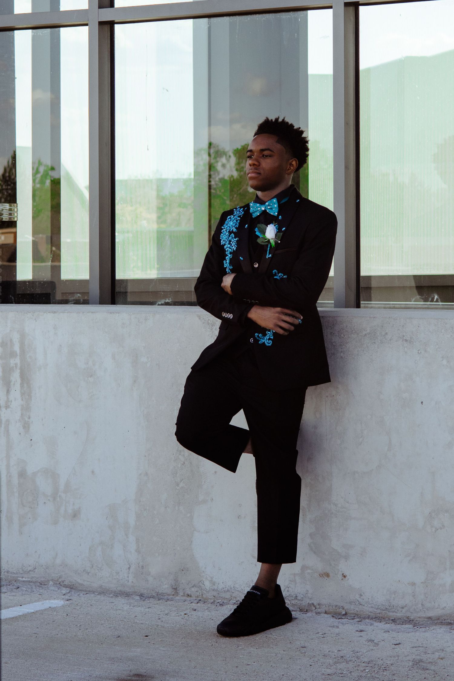 A senior in high school posing for prom pictures.