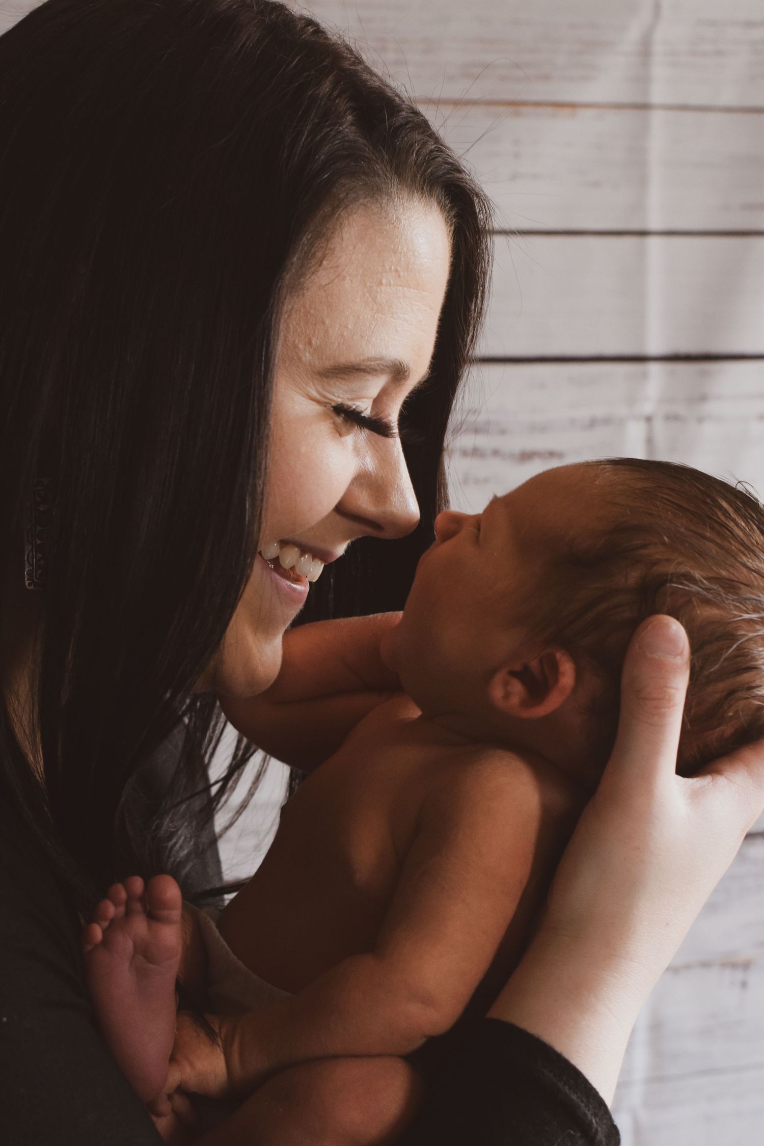 Intimate black and white portrait showing tender moments between parent and baby.