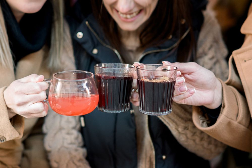 Close-up shots of colorful cocktails being shared among friends at a cafe.
