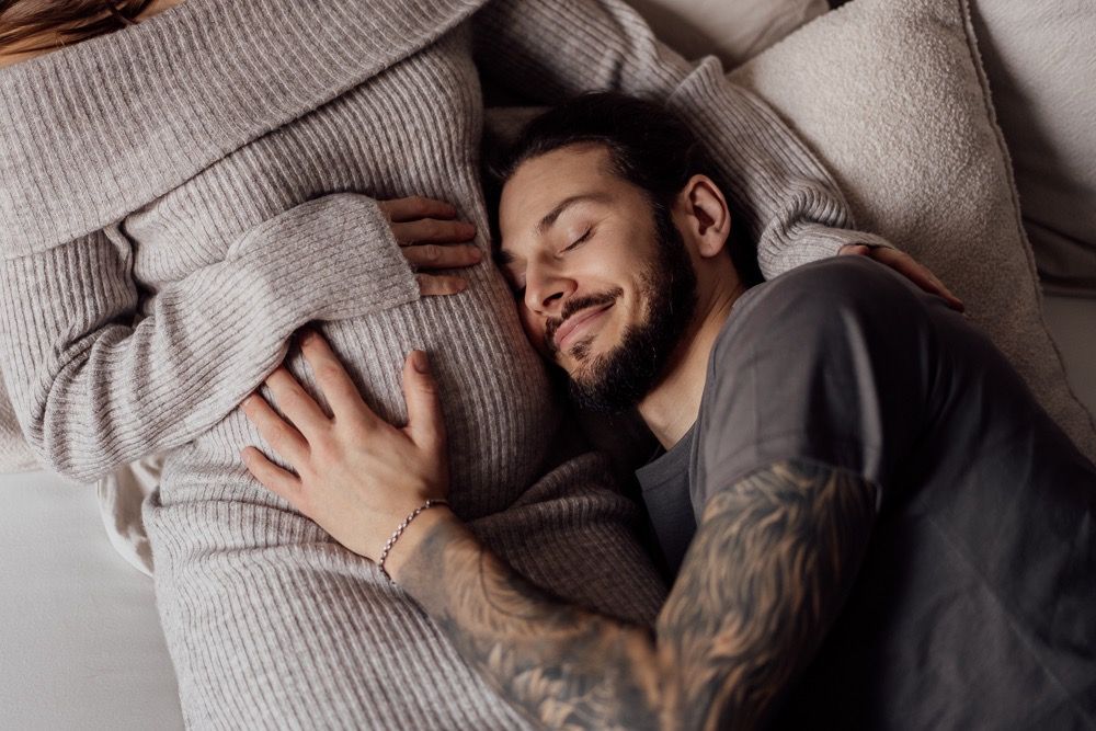 A relaxed moment captured on a comfortable couch with soft knit textures and neutral tones.