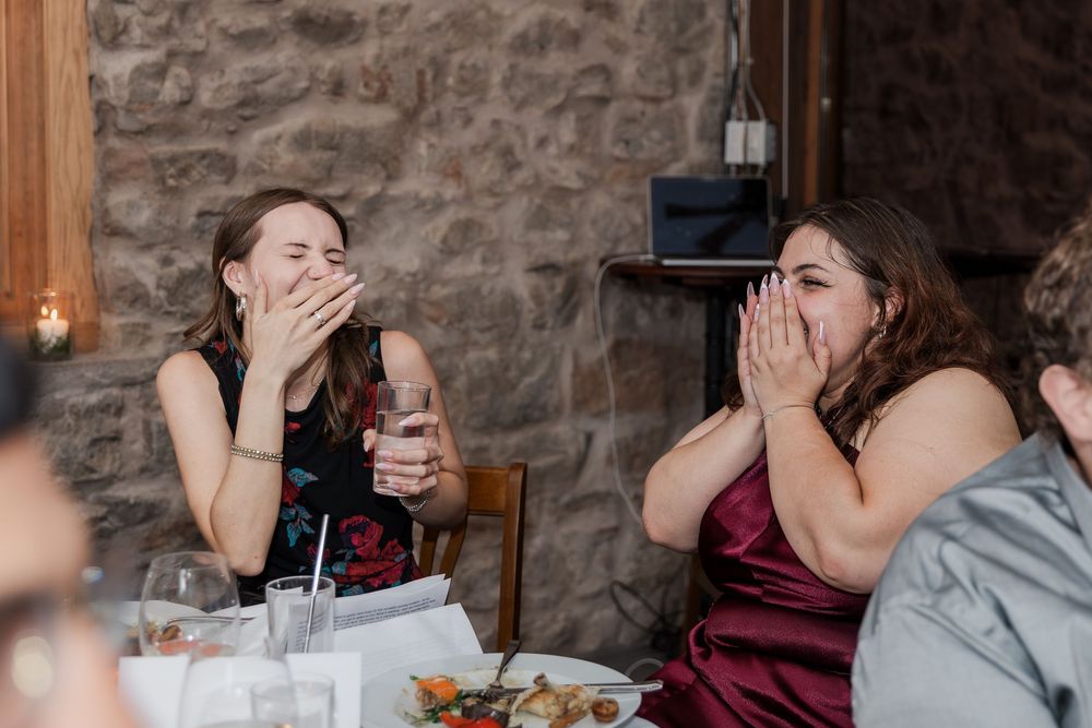 Grooms daughters laugh at a moment during the speeches in the Carriage House at Vineland Estate Winery.