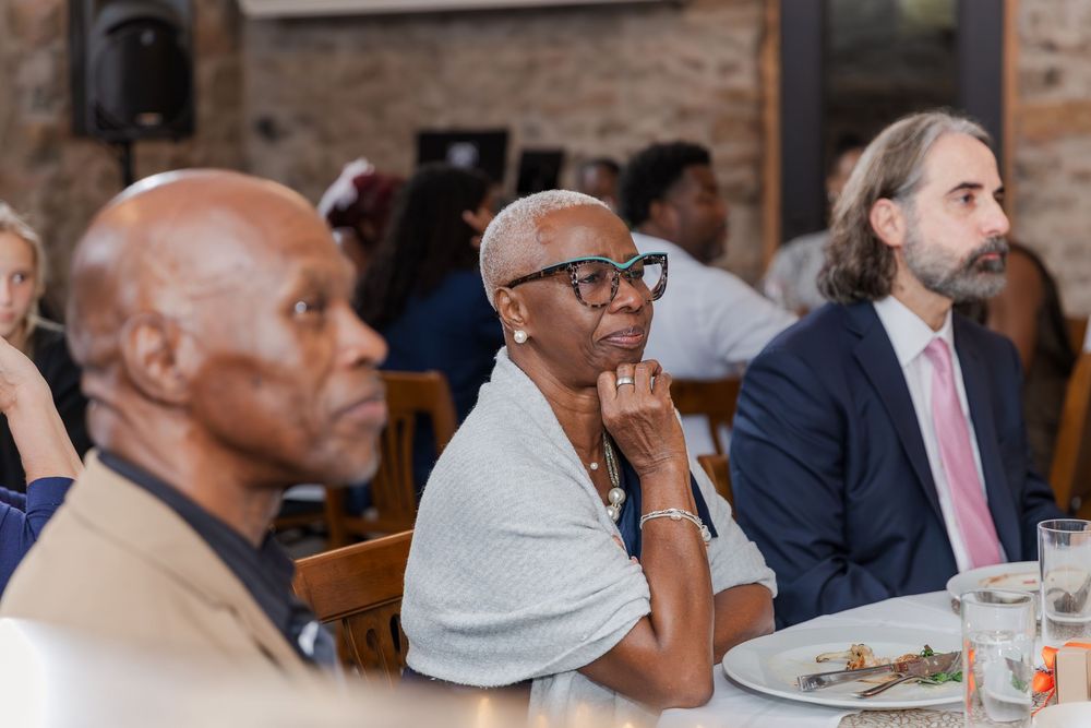 Wedding guests sit and listen intently to speeches in the Carriage House at Vineland Estate Winery.