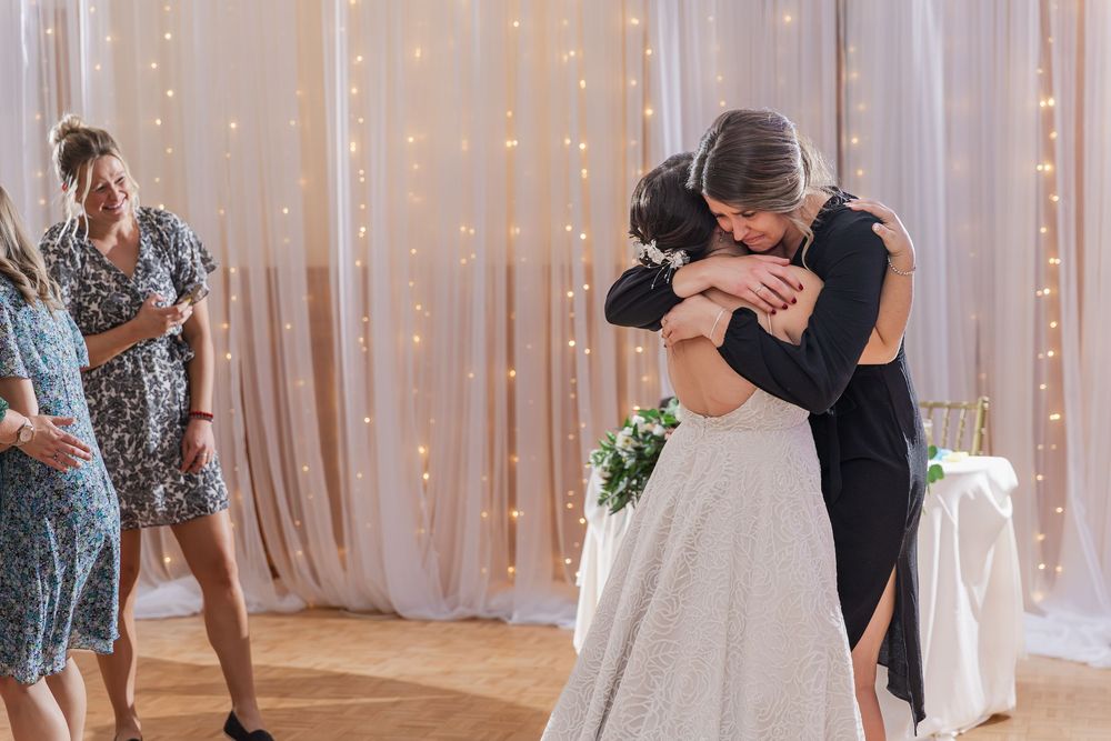 An intimate embrace between a bride and sister-in-law after a speech at the Old Courthouse in London, Ontario.