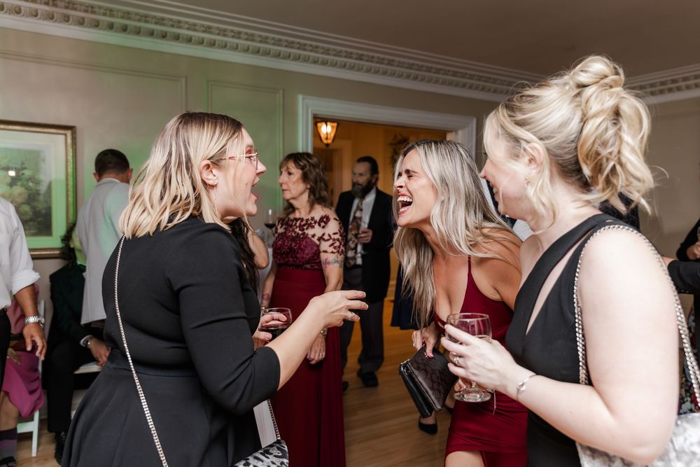 Wedding guests dancing and celebrating on the main floor of Paletta Mansion in Burlington, Ontario.