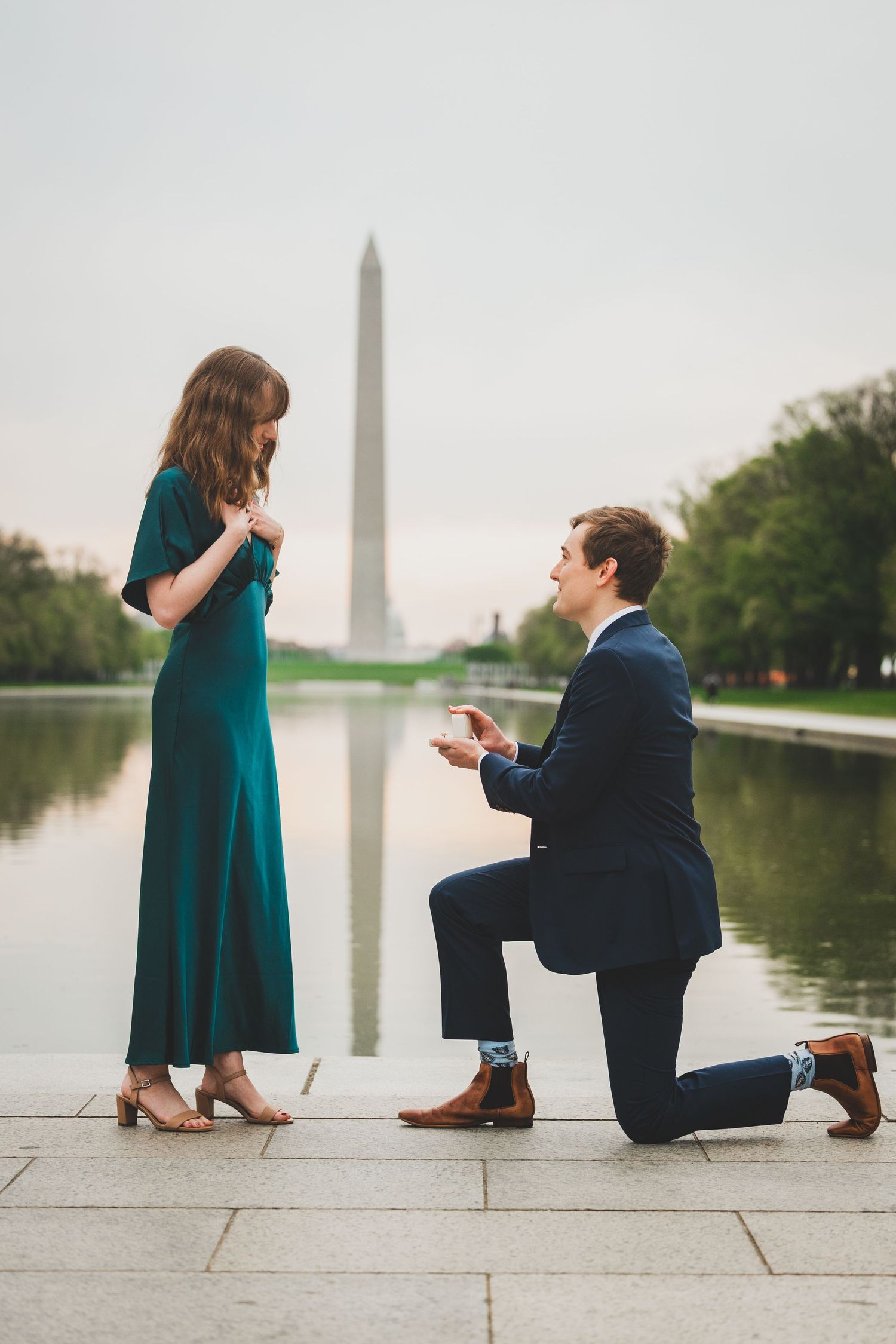 A romantic proposal sequence captured in four photos at the Lincoln Memorial reflecting pool in Washington DC.