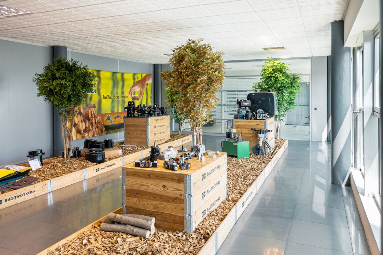 Contemporary workspace corridor featuring wooden planters, green plants, and minimalist design elements.