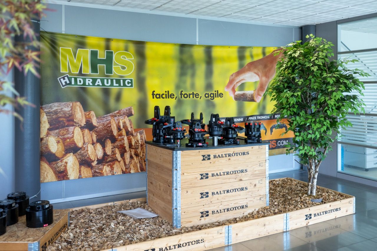 Modern office interior with sleek display cases showcasing food and beverage products against a bright yellow wall.