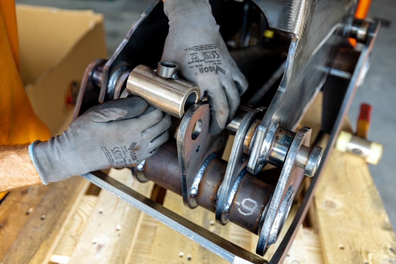 Close-up view of a woodworking router bit being used to shape the edge of a wooden board.