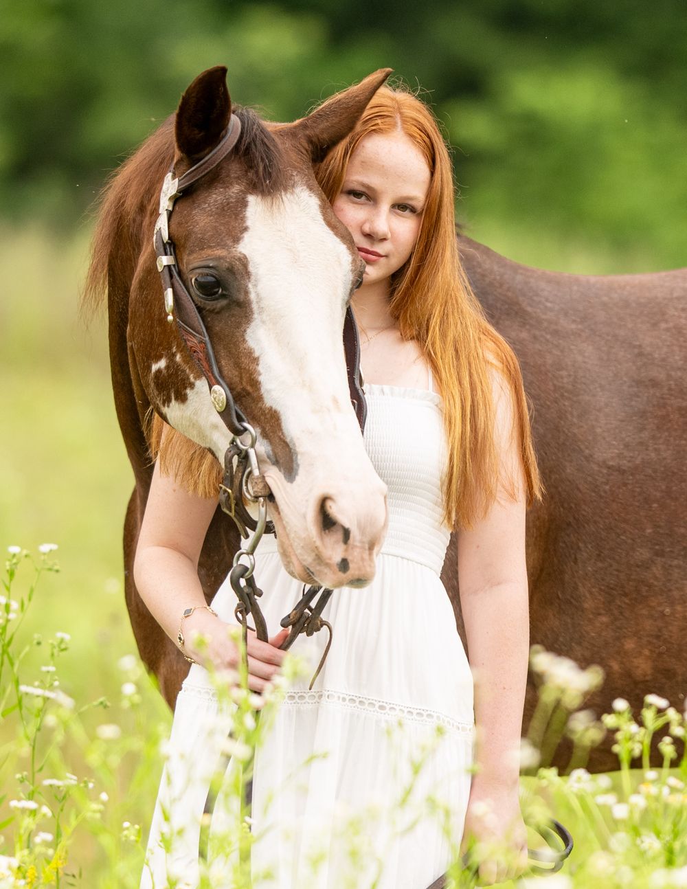 Horse and owner portraits in a summer meadow filled with white wildflowers.