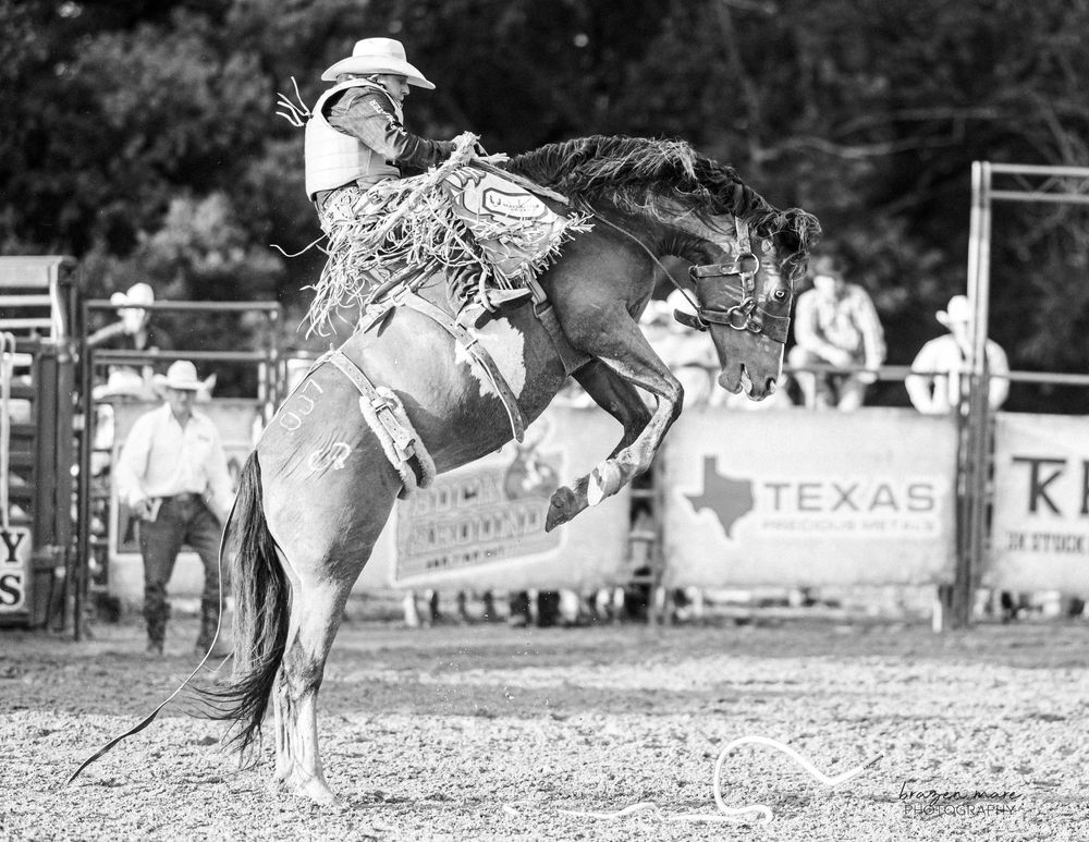 Black and white rodeo action sequence showing fast-paced barrel racing competition.