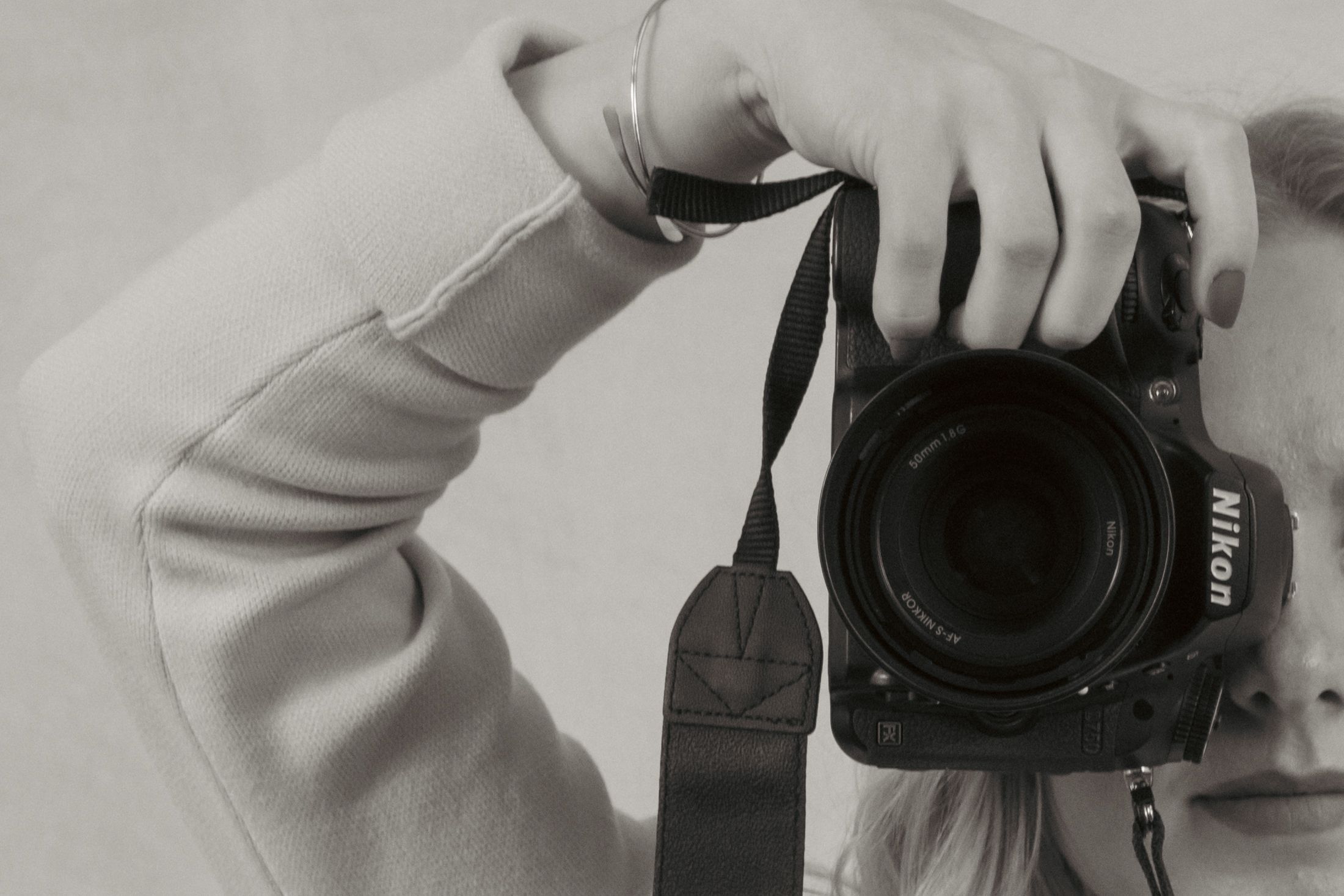Close-up shots of camera equipment and hands holding photography gear.