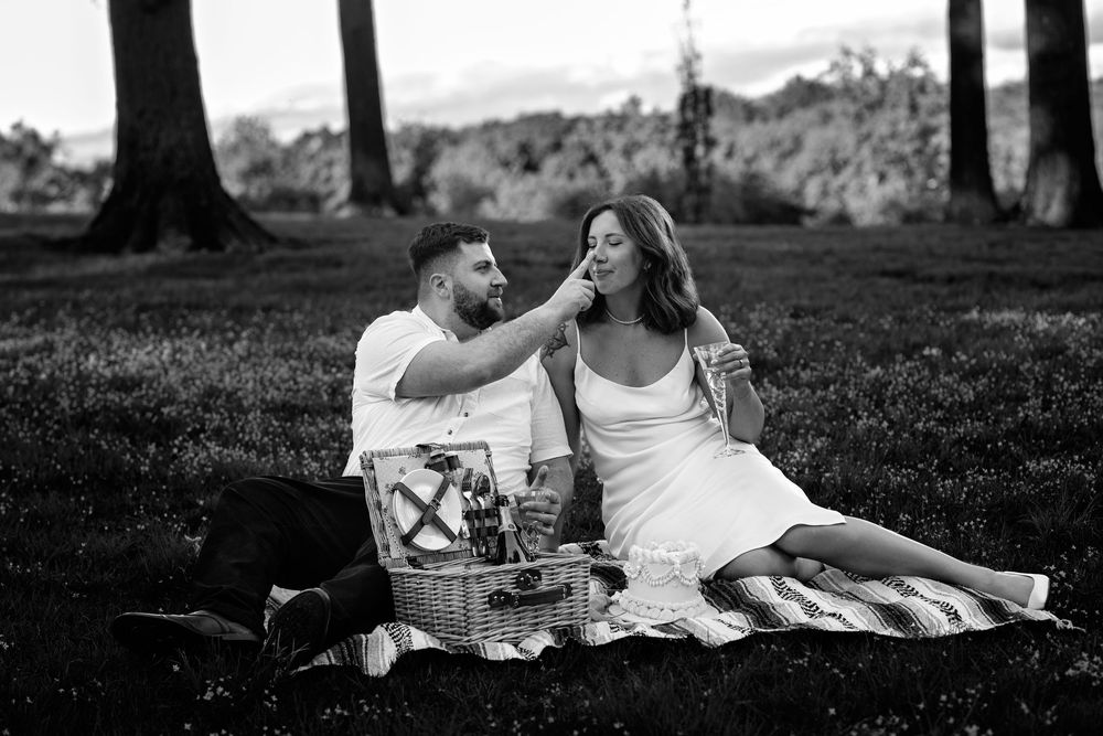 A collection of black and white romantic outdoor picnic scenes showing couples relaxing on blankets in nature.