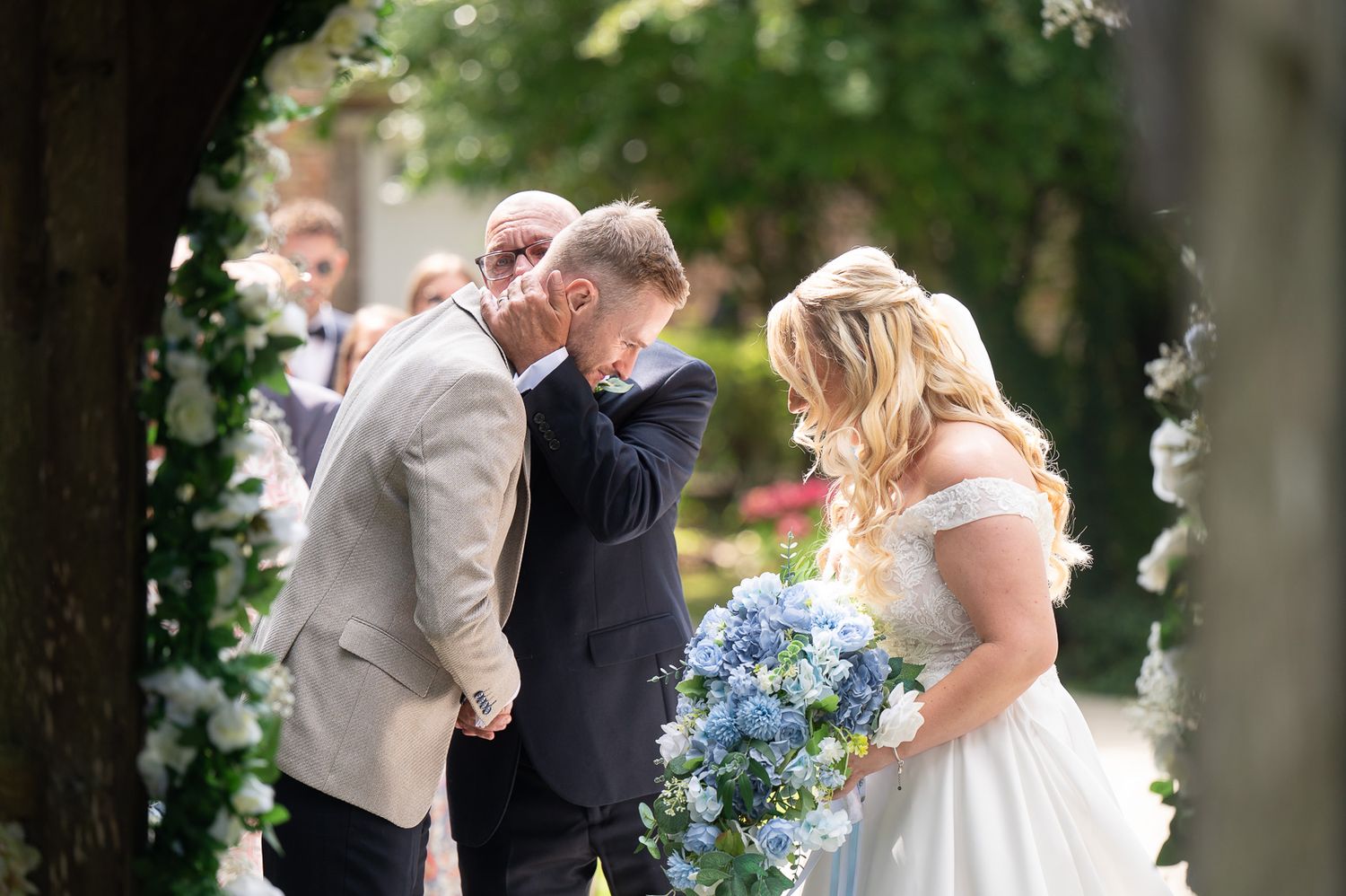 Bride and her father at top of aisle, emotional hug with groom during Solton Manor outdoor wedding ceremony - SHOT by JFK Photography.