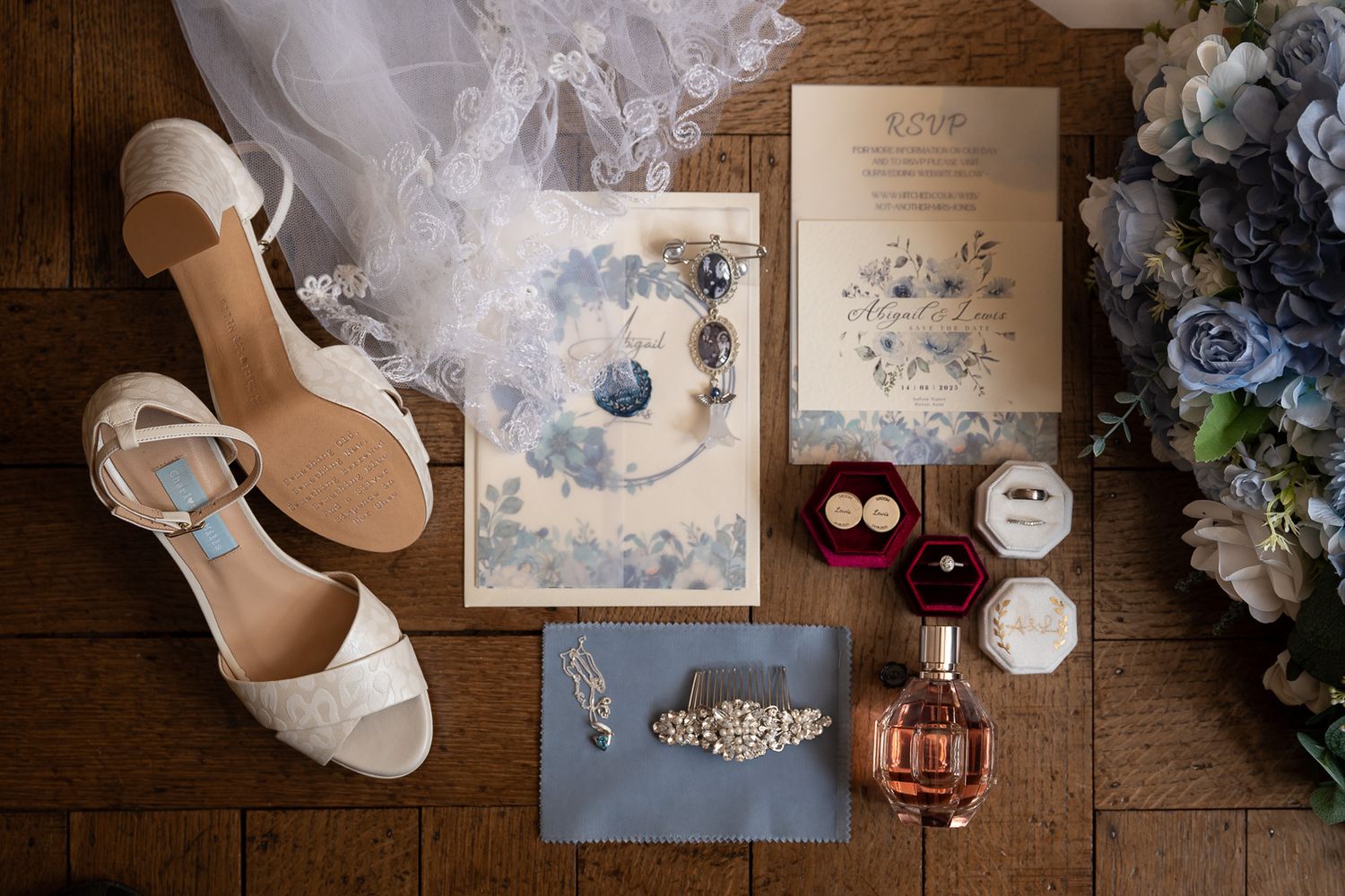 Luxury bridal flat lay at Solton Manor with perfume bottle, veil, and wedding invite, Kent wedding photographer SHOT by JFK.
