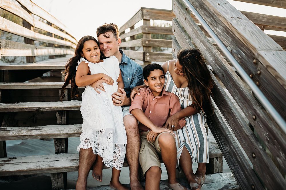 Family photoshoot series showing intimate moments together on wooden steps in warm lighting.