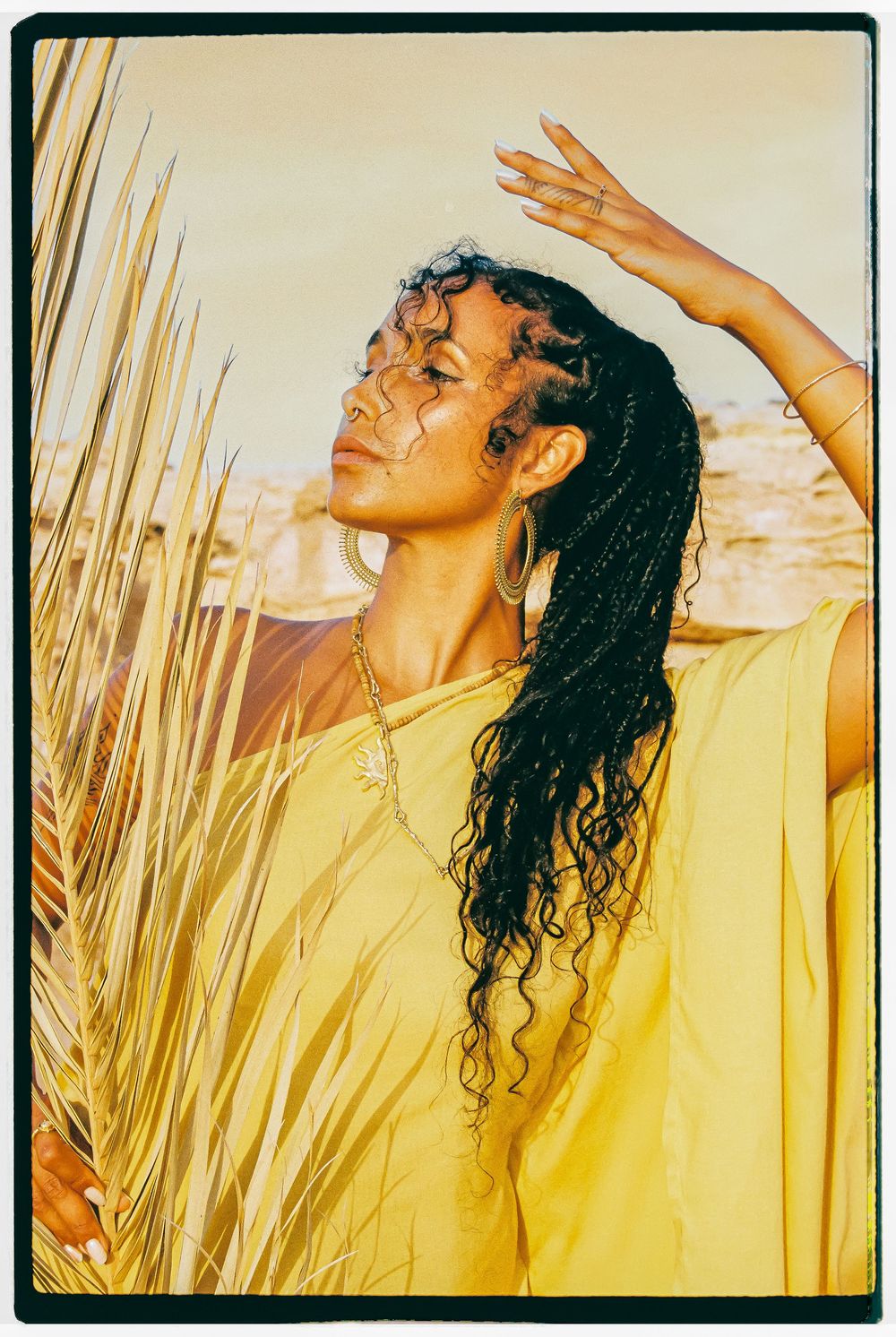 A figure in a yellow top poses expressively against golden sunlight and tall grass in a series of artistic shots.