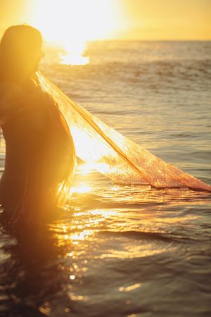 Golden sunlight sparkles on ocean waves during a magical sunset moment.
