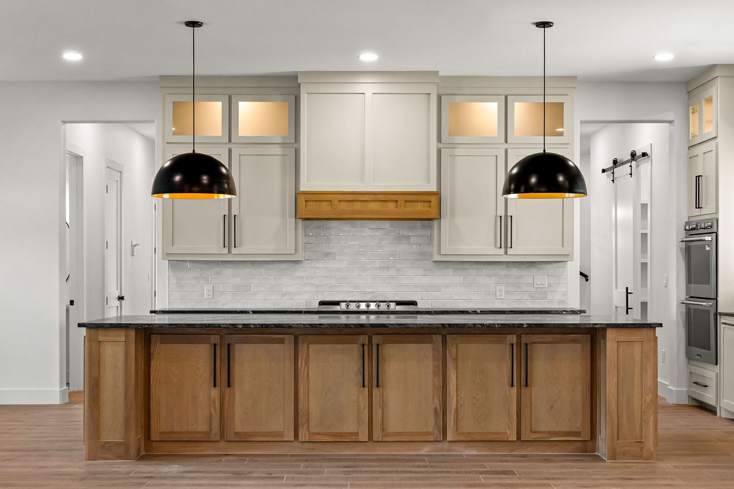 newly built house with lights on black pendants wide space wood cabinets painted cabinets luxury home