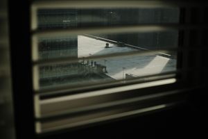 Reflective glass windows of a modern building create abstract patterns.