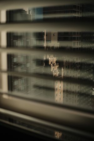 Abstract blurred architectural reflection through glass windows.