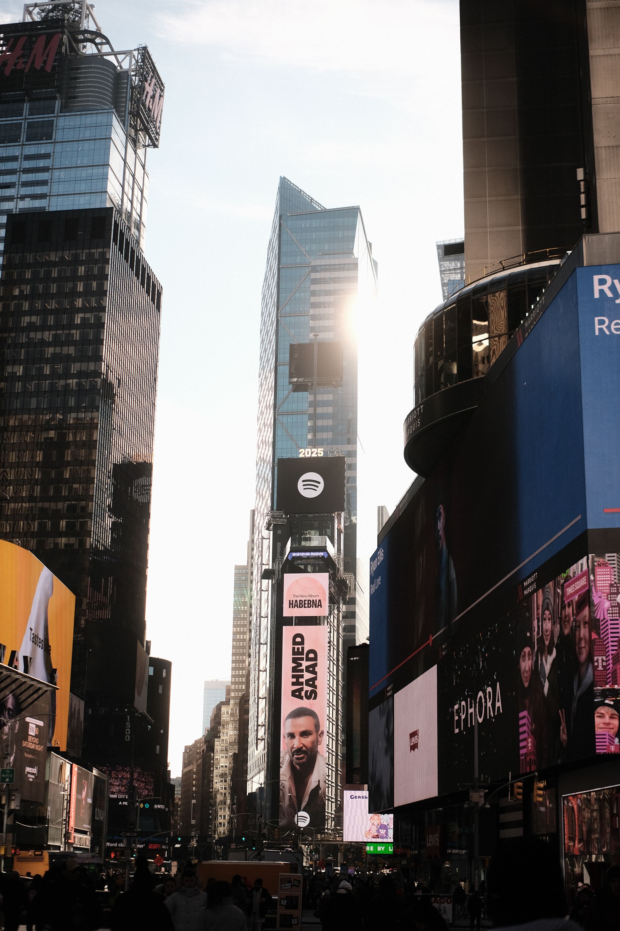 Times Square at dusk with illuminated billboards and towering skyscrapers.