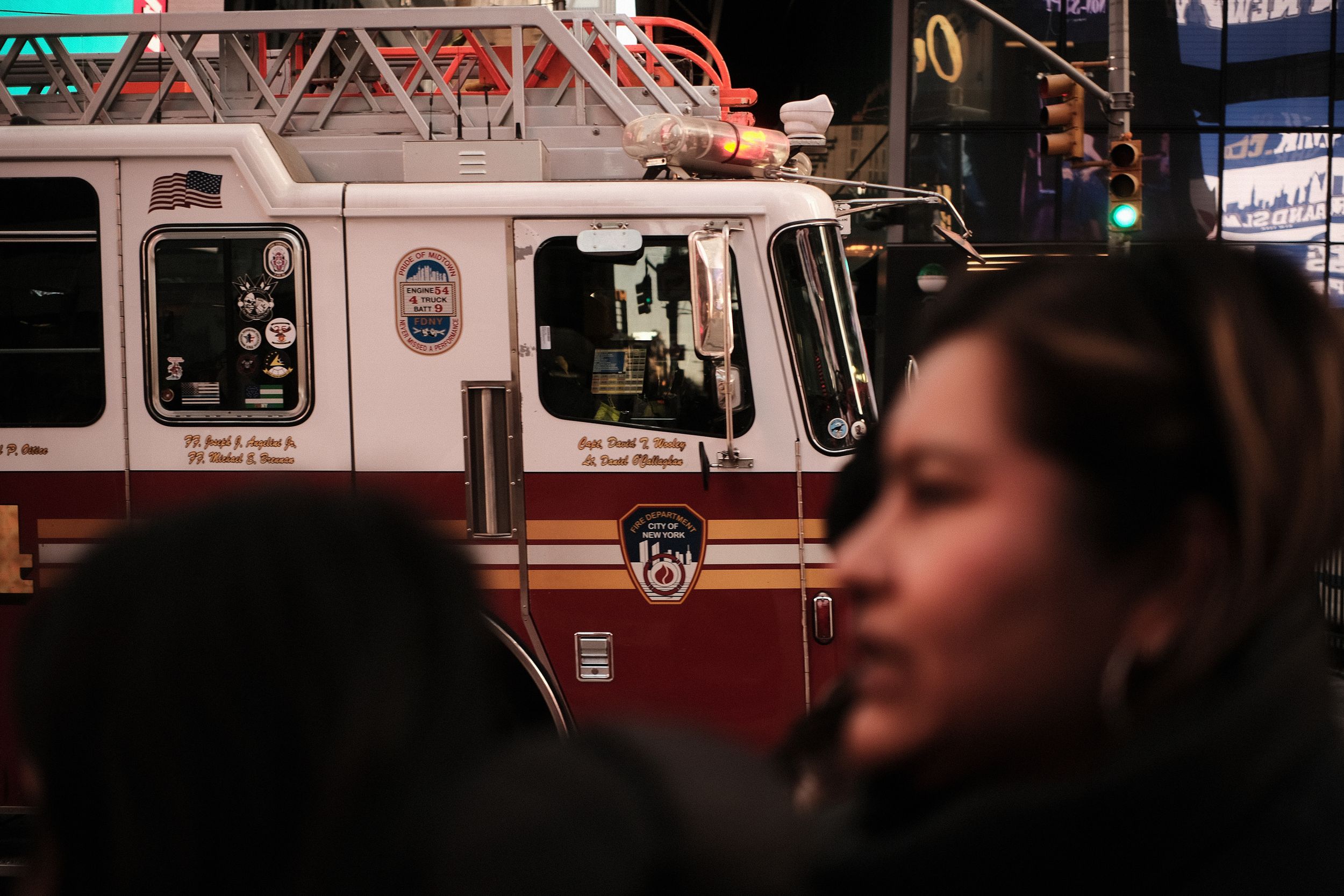 Emergency vehicles parked on dark city street at night.