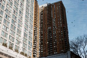 High-rise residential apartment building against blue sky in New York City.