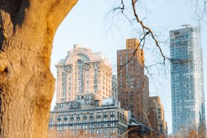 Historic brick buildings and modern towers create a layered cityscape against a bright sky.