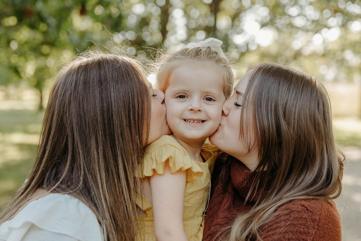 A series of candid family moments captured outdoors showing affectionate interactions between parent and child.