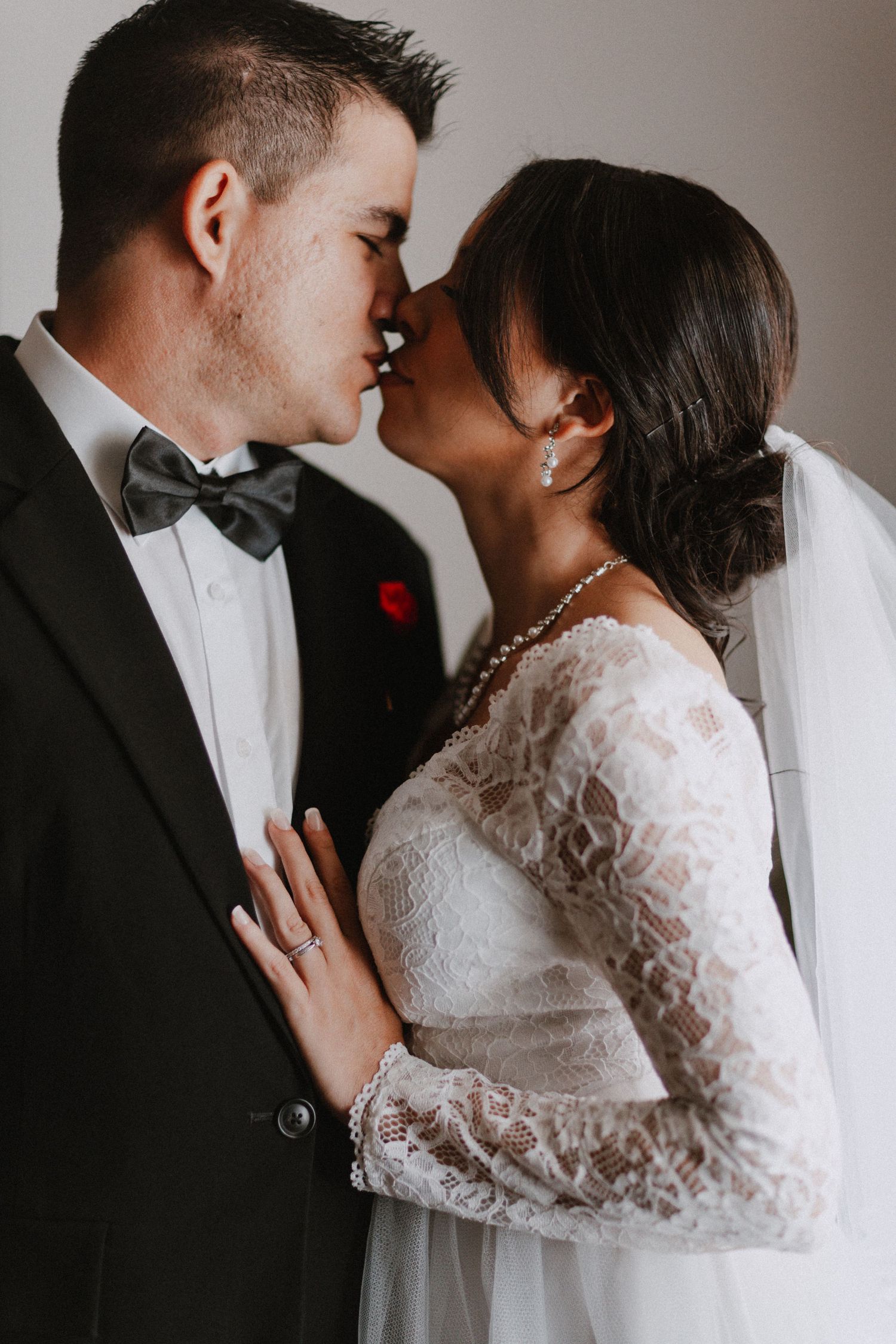 Intimate black and white wedding portrait showing couple in formal attire.