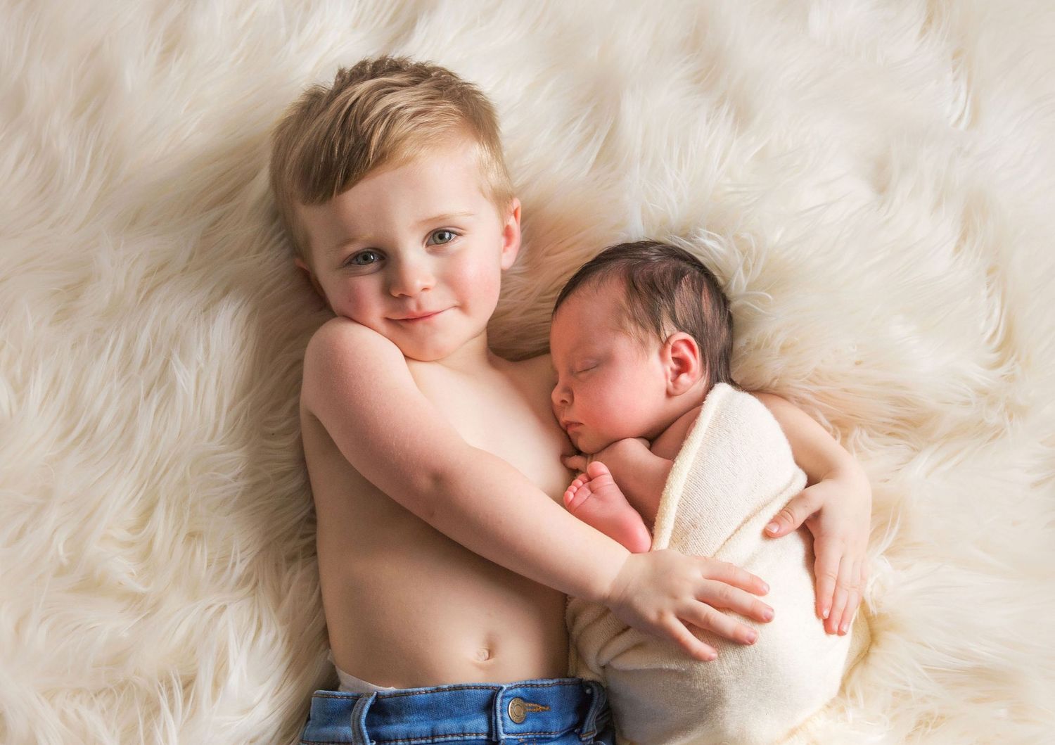 Intimate black and white newborn photography series with soft lighting.