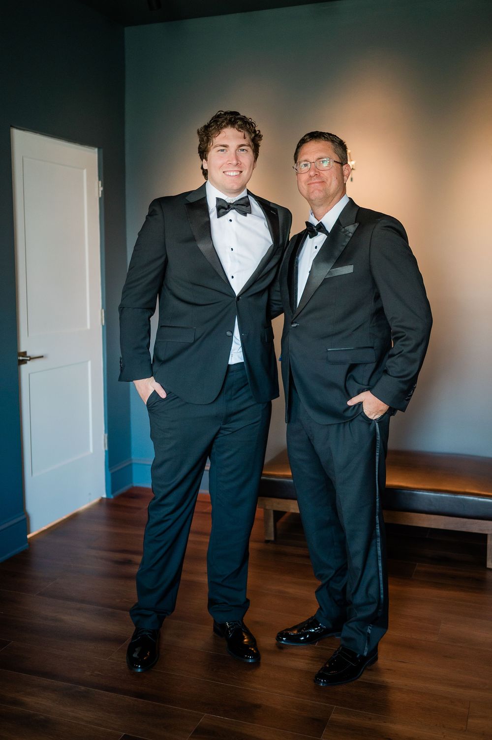 Groomsmen in black tuxedos pose playfully in sequence of candid shots on hardwood floor.