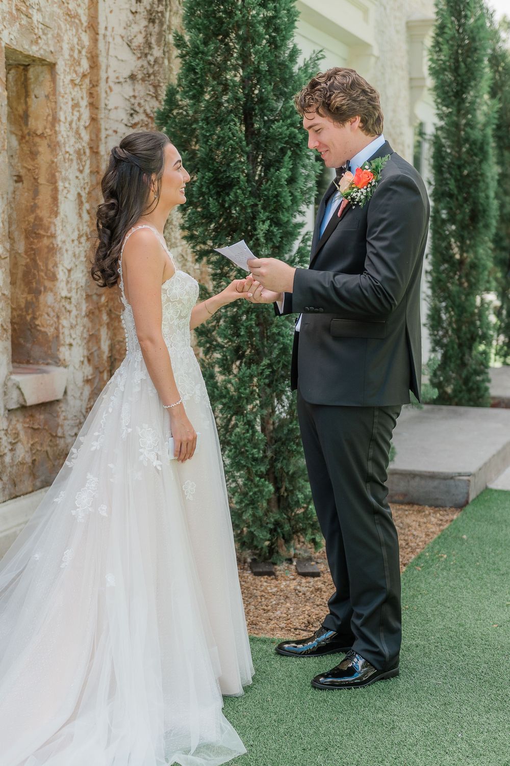 First look wedding moment captured in an outdoor garden setting.