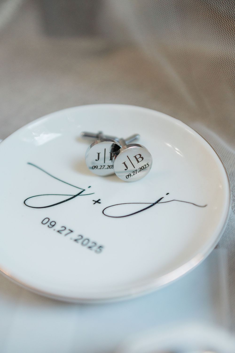 White ceramic plates with minimalist monogram designs and wedding date details.