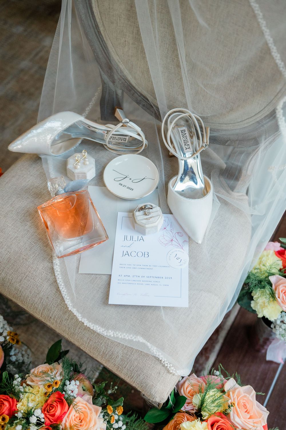 Wedding accessories and floral arrangements displayed on burlap with name cards and decorative details.