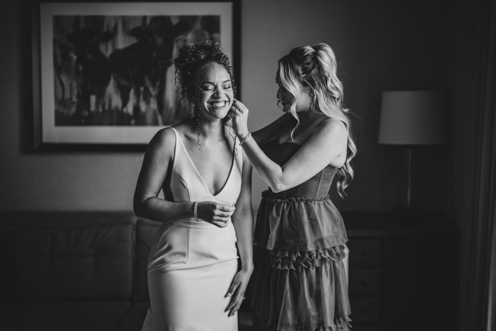 Intimate black and white photo showing emotional wedding day preparation moments.