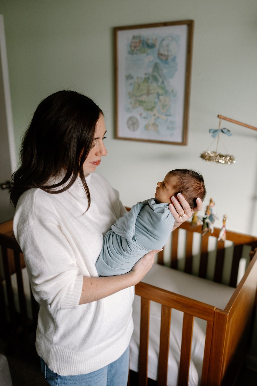 A sequence of photos showing someone in a white sweater leaning over a wooden crib in a nursery setting.