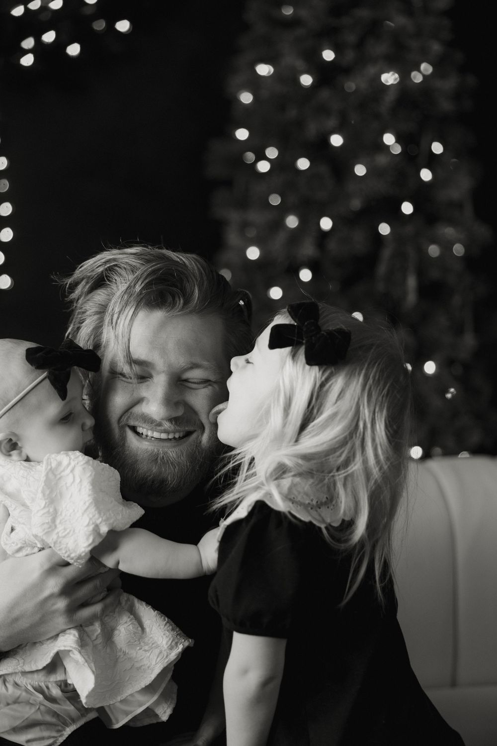 Playful black and white photo sequence showing couple sharing tender moments with string lights in background.