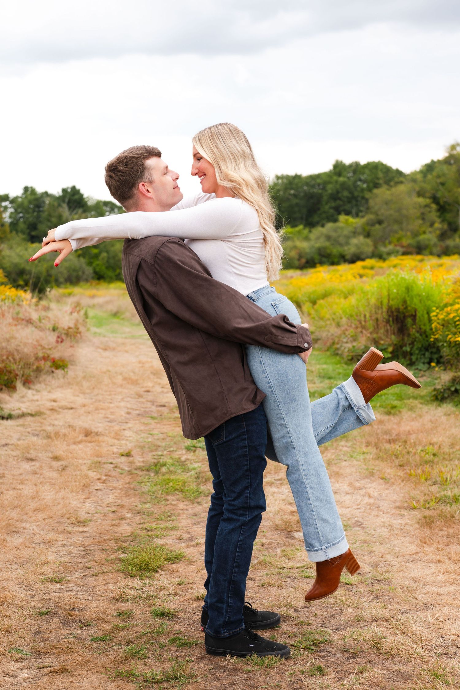 Couple sharing a romantic moment against a red wall.