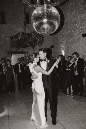 Black and white photos of couples dancing under a disco ball in an elegant venue with brick walls.