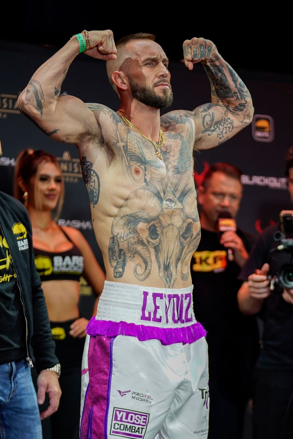 Bare knuckle fighter posing on the scale at pre-fight weigh-in, intense combat sports moment captured by SRX Media Group.