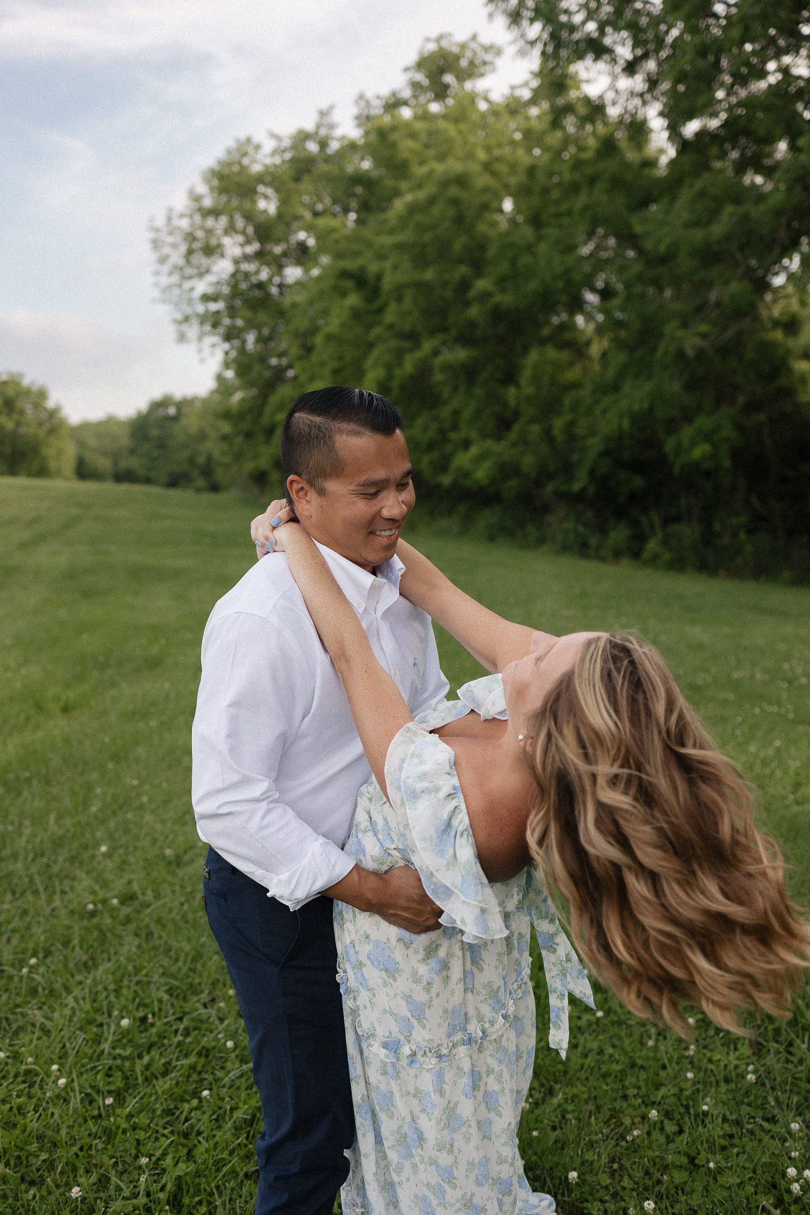 husband swaying wife back into a dip as her hair blows in the breeze