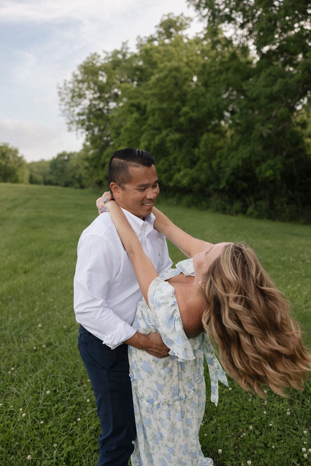 husband swaying wife back into a dip as her hair blows in the breeze