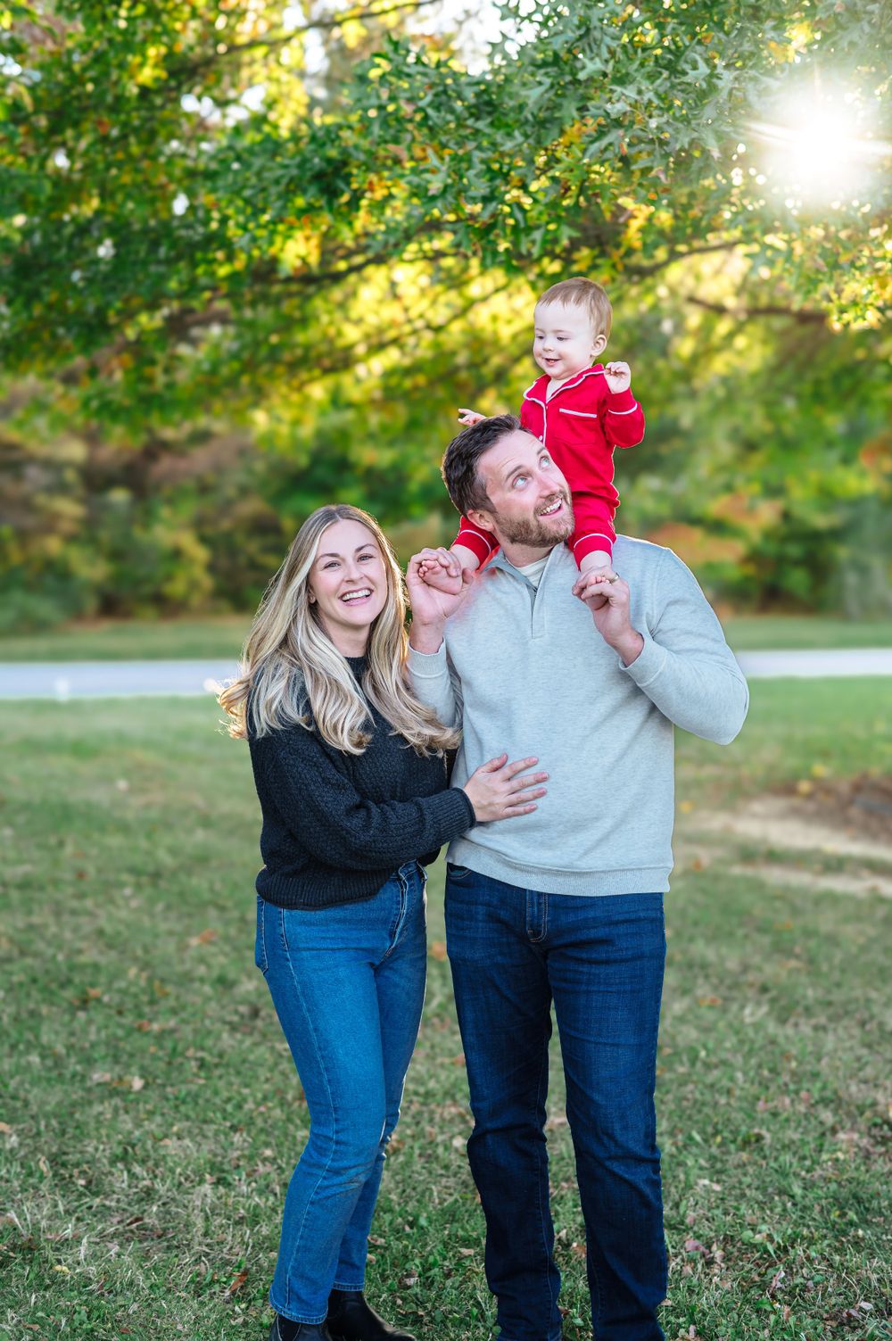 A playful family photoshoot in a sunny park during autumn.
