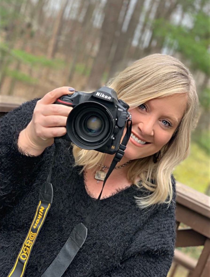 A picture of myself, holding a Nikon camera